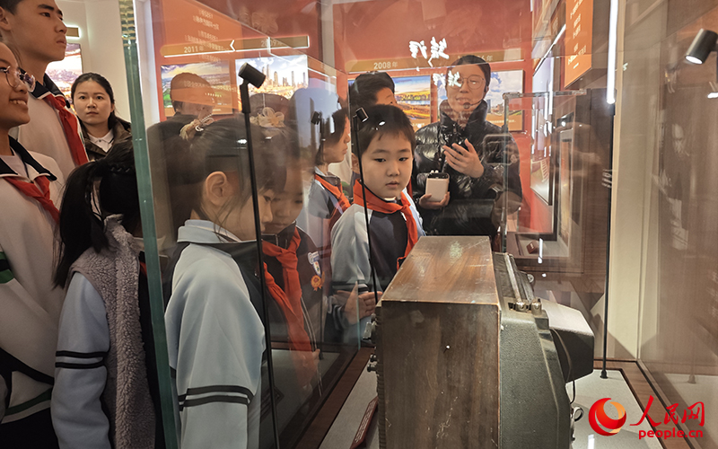 学生们透过天津生产的全国第一台电视机了解天津发展。人民网记者 孙一凡摄